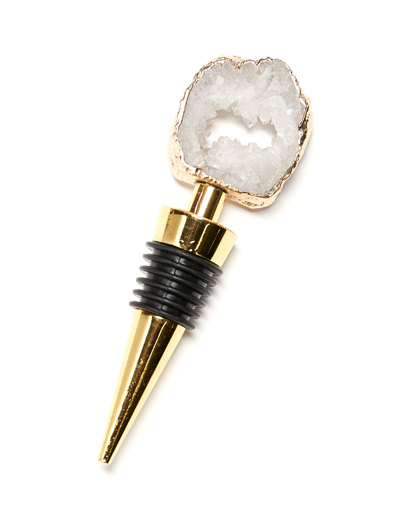 Mini gold plated white geode bottle stopper. Everything you loved about our crystal bottle stoppers, but MINI   Our natural crystal bottle stoppers are a lovely accessory to add to your bar stool when you're entertaining or for your nights in, to add some extra elegance. With natural Geode Crystal, coated in yellow gold plating, this bottle stopper is perfect as a unique table decoration. Yellow Gold Plating  9-11 cm  Note: Due to our crystals being 100% natural, shape and colour patterns will vary.