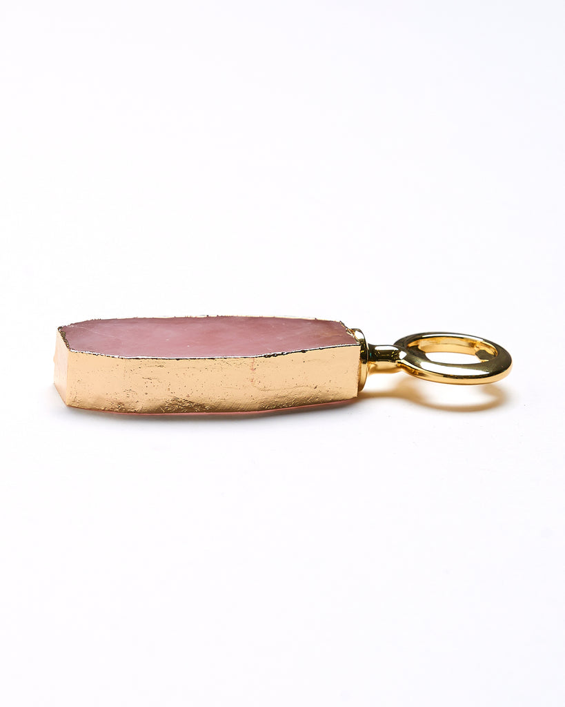 Side view of Gold plated rose quartz crystal bottle opener. Our natural crystal bottle openers are a lovely accessory to add to your bar stool when you're entertaining or for your nights in to add some extra elegance. With natural Rose Quartz, coated in yellow gold plating, this bottle opener will add style and luxury to any event .