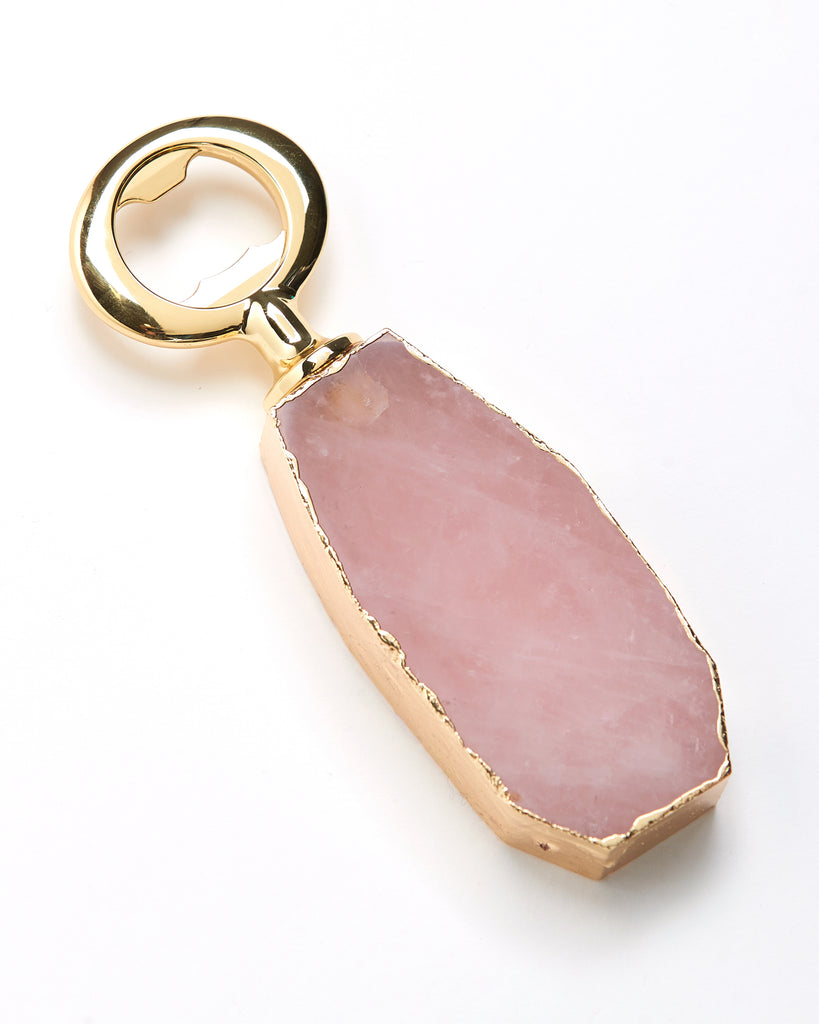 Gold plated rose quartz crystal bottle opener. Our natural crystal bottle openers are a lovely accessory to add to your bar stool when you're entertaining or for your nights in to add some extra elegance. With natural Rose Quartz, coated in yellow gold plating, this bottle opener will add style and luxury to any event .