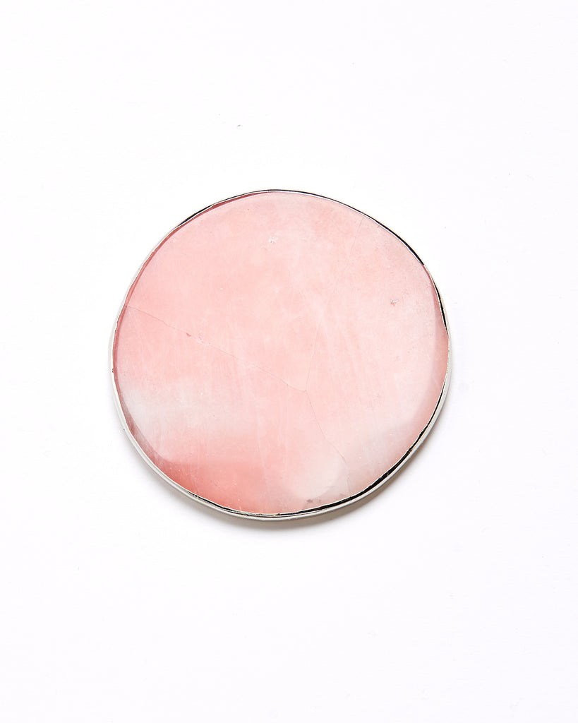 Silver plated rose quartz  crystal coaster. Our natural crystal coasters are the perfect addition to your dining room or coffee table. With natural Rose Quartz, coated in silver plating, this coaster is an easy way to elevate the luxury in your home.  Rose Quartz Crystal  80-120 mm  Silver Plating  Please note: Due to our crystals being 100% natural, shape and colour patterns will vary.   