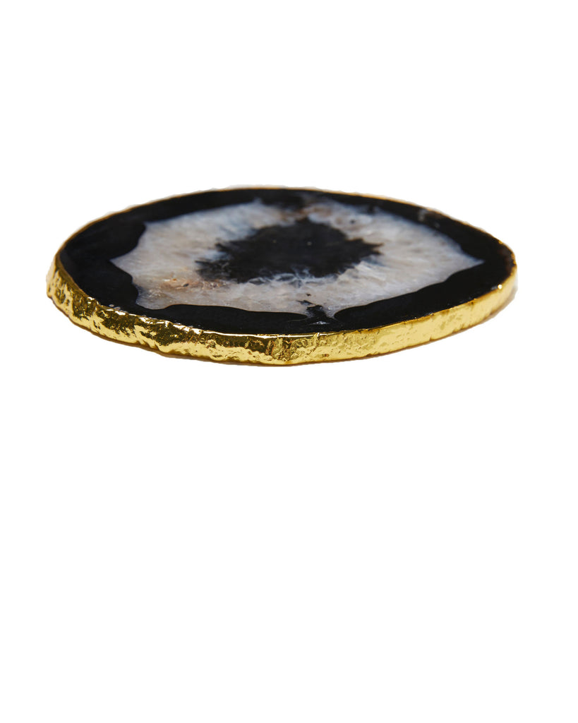 Gold plated black agate crystal coaster. Our natural crystal coasters are the perfect addition to your dining room or coffee table. With natural black agate from Brazil, coated in yellow gold plating, this coaster is an easy way to elevate the luxury in your home.   Black Agate Crystal   80-120 mm   Yellow Gold Plating  Please note: Due to our crystals being 100% natural, shape and colour patterns will vary.   