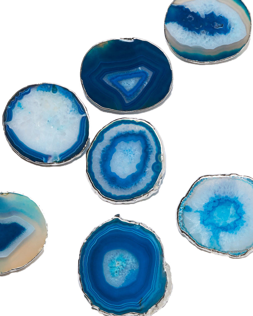 4 Silver plated blue agate crystal coasters.  Our natural crystal coasters are the perfect addition to your dining room or coffee table. With natural blue agate from Brazil, coated in silver plating, this coaster is an easy way to elevate the luxury in your home.  Blue Agate Crystal  100-120 mm  Silver Plating  Please note: Due to our crystals being 100% natural, shape and colour patterns will vary.