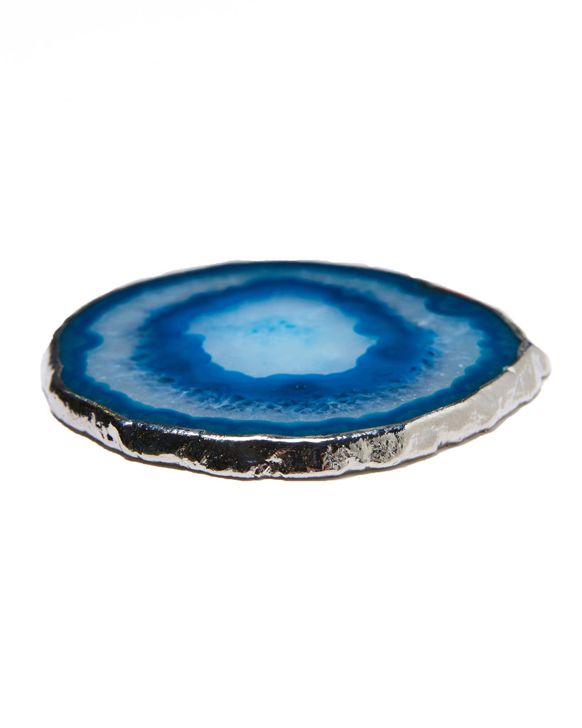 Silver plated agate crystal coaster.  Our natural crystal coasters are the perfect addition to your dining room or coffee table. With natural blue agate from Brazil, coated in silver plating, this coaster is an easy way to elevate the luxury in your home.  Blue Agate Crystal  100-120mm  Silver Plating  Please note: Due to our crystals being 100% natural, shape and colour patterns will vary.