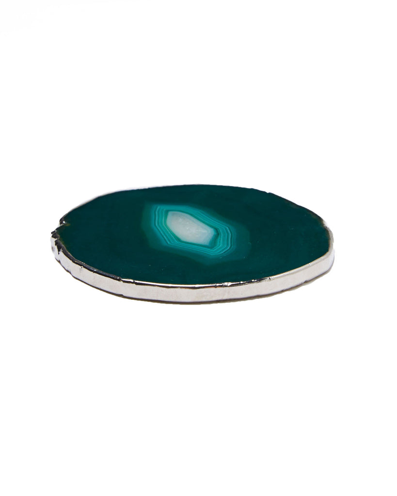 Our natural crystal coasters are the perfect addition to your dining room or coffee table. With natural green agate from Brazil, coated in silver plating, this coaster is an easy way to elevate the luxury in your home.   Green Agate Crystal   80-120mm   Silver Plating  Please note: Due to our crystals being 100% natural, shape and colour patterns will vary.