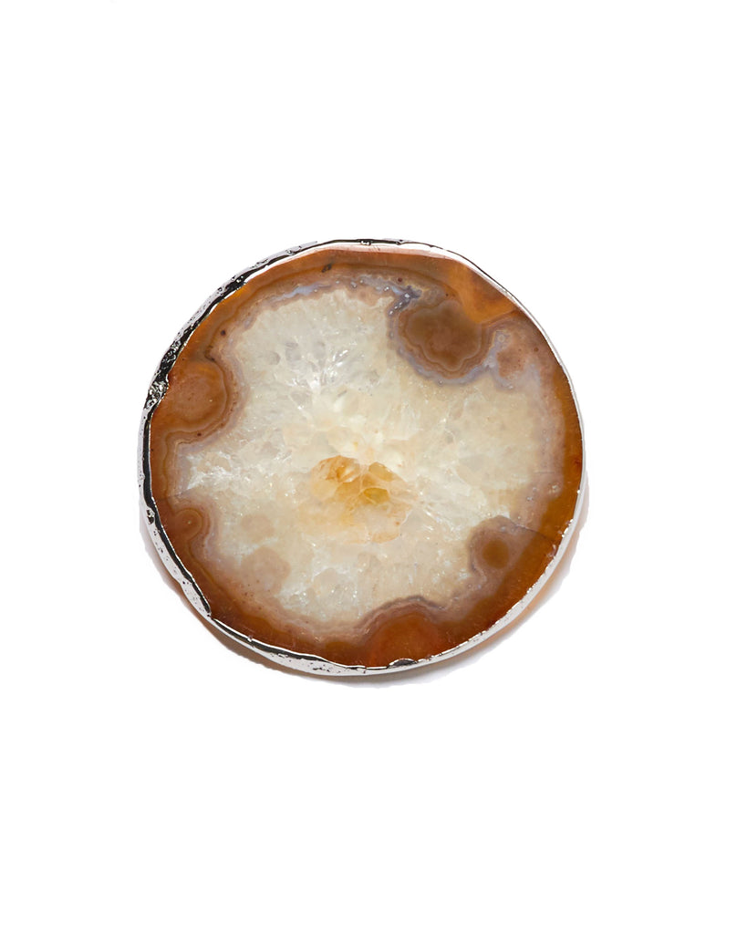 Silver plated amber agate crystal coaster. Our natural crystal coasters are the perfect addition to your dining room or coffee table. With natural amber agate, coated in silver plating, this coaster is an easy way to elevate the luxury in your home.  Amber Agate Crystal  80-120 mm  Silver Plating  Please note: Due to our crystals being 100% natural, shape and colour patterns will vary.